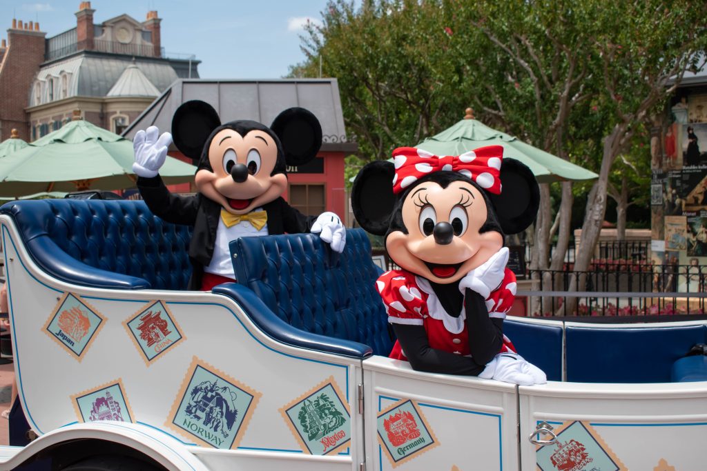 Mickey and Minnie in a coach in the parade